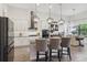 Beautiful kitchen with island seating, pendant lights, and seamless flow to the dining area at 9307 San Jose Blvd, Howey In The Hills, FL 34737