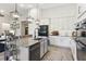 Bright and airy kitchen featuring a large island, stainless appliances, and seamless design at 9307 San Jose Blvd, Howey In The Hills, FL 34737