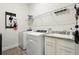 Functional laundry room with utility sink, modern washer and dryer, and ample shelving space at 9307 San Jose Blvd, Howey In The Hills, FL 34737