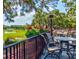 Outdoor patio area with seating, a view of the golf course and a pond at 9307 San Jose Blvd, Howey In The Hills, FL 34737