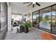 An open patio features comfortable seating arrangements, ceiling fans and serene outdoor views at 9307 San Jose Blvd, Howey In The Hills, FL 34737