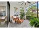 Inviting outdoor patio with wicker furniture, potted plants and views of the landscape at 9307 San Jose Blvd, Howey In The Hills, FL 34737