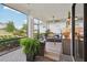 Relaxing screened patio with comfortable furniture, ceiling fan and views of the lush backyard at 9307 San Jose Blvd, Howey In The Hills, FL 34737