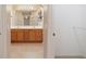 A view from the Primary walk-in closet shows the double sink vanity in the bathroom at 997 Nash Loop, The Villages, FL 32162