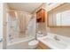 Neutral bathroom featuring a shower-tub combo with a cream-colored shower curtain at 997 Nash Loop, The Villages, FL 32162