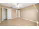 Bedroom with walk-in closet features tile flooring and neutral walls at 997 Nash Loop, The Villages, FL 32162