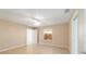 The bedroom features tile floors, ceiling fan, and a window for natural light at 997 Nash Loop, The Villages, FL 32162