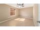 Neutral bedroom featuring a ceiling fan and a window allowing natural light at 997 Nash Loop, The Villages, FL 32162