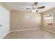 Neutral bedroom featuring a ceiling fan and a window allowing natural light at 997 Nash Loop, The Villages, FL 32162