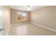 Bedroom features tile flooring and natural light from the window at 997 Nash Loop, The Villages, FL 32162