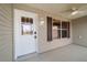 A home's exterior showing a front door with window panes, a door knob lock, and a ceiling fan at 997 Nash Loop, The Villages, FL 32162