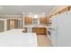 Kitchen featuring white appliances, white countertops and tile flooring at 997 Nash Loop, The Villages, FL 32162