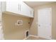 Laundry area featuring overhead cabinets at 997 Nash Loop, The Villages, FL 32162