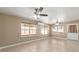 Large living space with bright windows and ceiling fans at 997 Nash Loop, The Villages, FL 32162