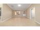 Bright, open living room with a window, neutral walls, and tile floors at 997 Nash Loop, The Villages, FL 32162
