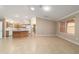 Bright, open-concept home features tile flooring, modern lighting, and kitchen with island at 997 Nash Loop, The Villages, FL 32162