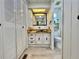 Well-lit bathroom features a sleek vanity, black hardware, and ample storage with a mirrored cabinet at 105 Temple W Cv, Leesburg, FL 34748
