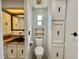 View of bathroom with a toilet, linen closet, and a window at 105 Temple W Cv, Leesburg, FL 34748