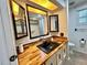 Bathroom featuring a wood countertop, black sink, storage and lighted ceiling at 105 Temple W Cv, Leesburg, FL 34748