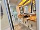 Bathroom featuring a sink with a black faucet, wood countertop and storage at 105 Temple W Cv, Leesburg, FL 34748