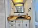 Bathroom with a rustic wood countertop and black sink and fixtures at 105 Temple W Cv, Leesburg, FL 34748
