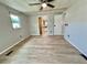 A bright bedroom features contemporary wood-look flooring, fresh paint, and versatile layout at 105 Temple W Cv, Leesburg, FL 34748