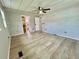 A spacious bedroom features modern wood-look flooring and neutral paint, awaiting your personal touch at 105 Temple W Cv, Leesburg, FL 34748