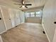 Bedroom featuring a ceiling fan, closet and wood-look floors at 105 Temple W Cv, Leesburg, FL 34748