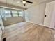 Bedroom with a fan, closet, and vinyl floors at 105 Temple W Cv, Leesburg, FL 34748