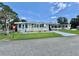 Charming single-story home with a well-manicured lawn and covered parking at 105 Temple W Cv, Leesburg, FL 34748