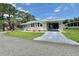 Charming single-story home with a well-manicured lawn and covered parking at 105 Temple W Cv, Leesburg, FL 34748