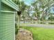 Charming exterior view featuring a lush lawn, a tranquil pond and a quaint community landscape from the home's side at 105 Temple W Cv, Leesburg, FL 34748