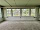 Spacious Florida room featuring relaxing lake views at 105 Temple W Cv, Leesburg, FL 34748