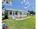 Charming single-story home featuring a welcoming front entrance with beautiful landscaping at 105 Temple W Cv, Leesburg, FL 34748