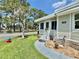 Close-up of the front door of a well-maintained home with lush landscaping and a tranquil water view at 105 Temple W Cv, Leesburg, FL 34748