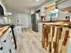Kitchen showcasing wood countertops, stainless steel refrigerator, and white cabinets at 105 Temple W Cv, Leesburg, FL 34748
