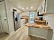Well-lit kitchen with stainless steel appliances, butcher block countertops, and ample cabinet space at 105 Temple W Cv, Leesburg, FL 34748