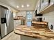 Bright kitchen features stainless steel appliances and wood countertops at 105 Temple W Cv, Leesburg, FL 34748