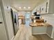 Modern kitchen features stainless steel appliances, butcher block countertops, and ample storage at 105 Temple W Cv, Leesburg, FL 34748