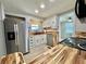 The kitchen boasts butcher block counters, stainless steel appliances, and white cabinets at 105 Temple W Cv, Leesburg, FL 34748