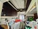 Small laundry room with white washer, storage, and exterior window at 105 Temple W Cv, Leesburg, FL 34748