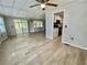 Open living room with ceiling fan and sliding glass doors for ample natural light at 105 Temple W Cv, Leesburg, FL 34748