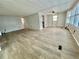 Spacious living room featuring wood-look floors and neutral paint at 105 Temple W Cv, Leesburg, FL 34748