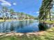 Scenic view of a serene pond with a fountain at 105 Temple W Cv, Leesburg, FL 34748