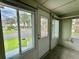 Enclosed porch with many windows overlooking the community and lake at 105 Temple W Cv, Leesburg, FL 34748