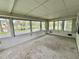Enclosed porch with many windows overlooking the lake and community at 105 Temple W Cv, Leesburg, FL 34748