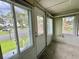Enclosed porch with many windows overlooking the community at 105 Temple W Cv, Leesburg, FL 34748