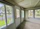 Enclosed porch with many windows overlooking the community and lake at 105 Temple W Cv, Leesburg, FL 34748