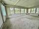 Bright sunroom features multiple windows with serene lake views at 105 Temple W Cv, Leesburg, FL 34748