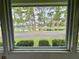 Relaxing lake view through a window at 105 Temple W Cv, Leesburg, FL 34748